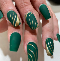 Matte green nails with gold swirl accents